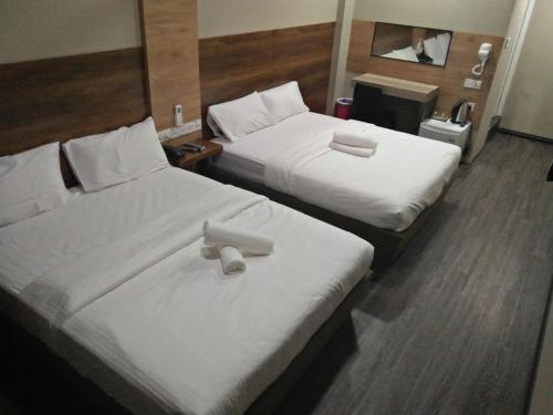 Кровать или кровати в номере Qing yun resthouse Bandar, Brunei Darussalam
