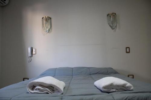 a bedroom with a bed with two towels on it at Rincon Secreto in San Rafael