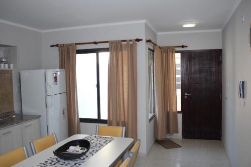 a kitchen with a table and chairs and a kitchen with a refrigerator at Rincon Secreto in San Rafael
