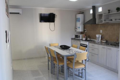 a kitchen with a table and chairs and a kitchen with a stove at Rincon Secreto in San Rafael