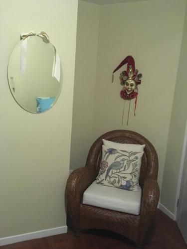 a mirror and a chair with a pillow at Elite Apartment in Cochabamba