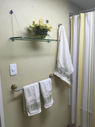 a bathroom with white towels and a shower at Elite Apartment in Cochabamba