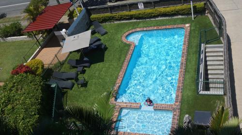 an overhead view of a swimming pool in a yard at Pacific Surf Absolute Beachfront Apartments in Gold Coast