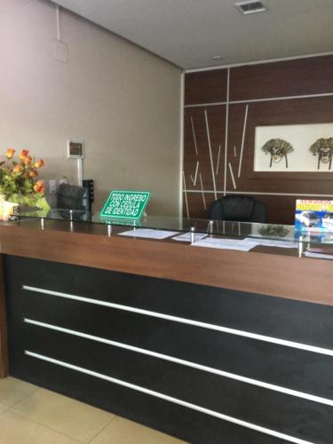 a reception desk with a laptop on top of it at Elite Apartment in Cochabamba