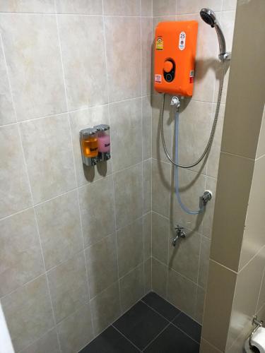 a shower with an orange dispenser in a bathroom at TAcozy693 in Hat Yai