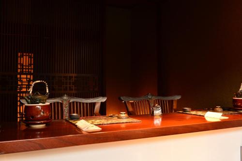 a wooden table with candles and other items on it at Balinese onsen ryokan Hakone Airu in Hakone