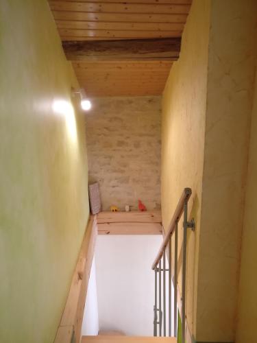 a staircase in a room with a wooden ceiling at Des Km à La Ronde in La Ronde