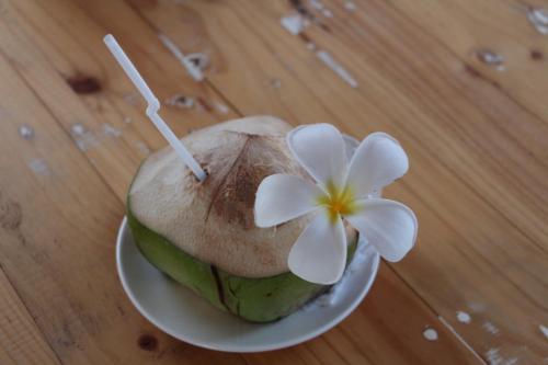 a cake with a flower on top of it on a table at The Castaway retreat in Feridhoo