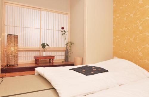 Postel nebo postele na pokoji v ubytování Shirakabanoyado - Osakajo