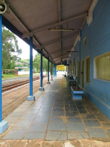 an empty train station with blue columns and benches at Colonial 4 B/R Home, Great for Families, Coonoor in Coonoor