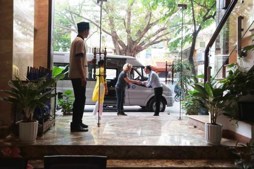 a group of people standing outside of a building at Hanoi Siva Luxury Hotel & Travel in Hanoi