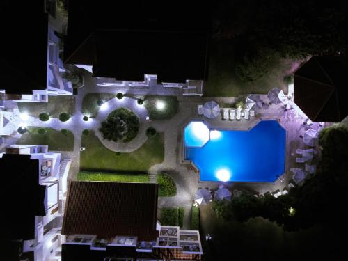 an overhead view of a swimming pool at night at Acrotel Lily Ann Village in Nikiti