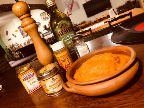 a bowl of food on a table with bottles of alcohol at Lo del Colo in Canning