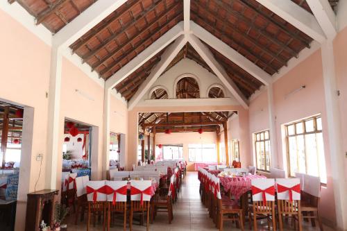 a dining room with red and white tables and chairs at Khách sạn Cà Ná in Phan Rang
