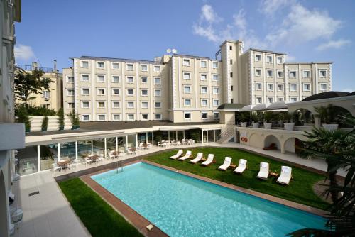 a hotel with a swimming pool in front of a building at Holiday Inn Istanbul City, an IHG Hotel in Istanbul