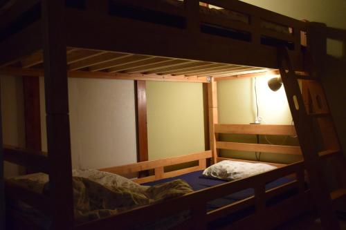 a bedroom with two bunk beds in a room at Guest house SHIE SHIMI in Tokyo