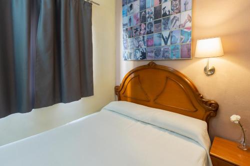 a bedroom with a bed and a picture on the wall at Hostel Malaga Inn in Torremolinos