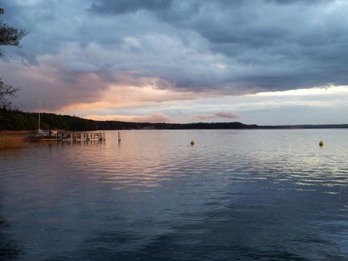 a large body of water with a cloudy sky at Seeblick III in Bad Saarow