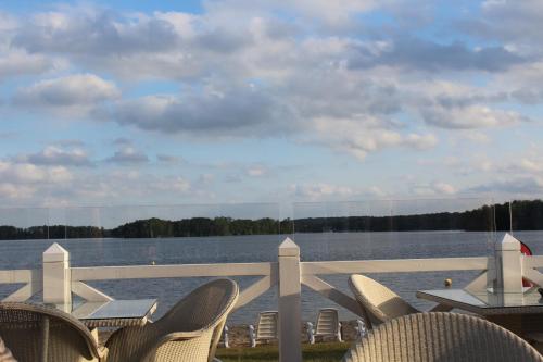 a patio with chairs and a view of the water at Seeblick III in Bad Saarow