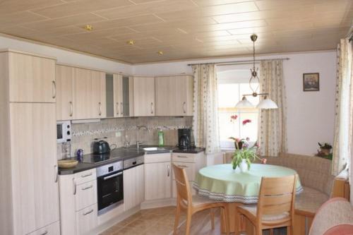 a kitchen with a table and a dining room at Birkenhof in Neukirchen beim Heiligen Blut