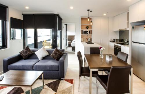 a living room with a couch and a table at Spencer Street Apartments in Melbourne