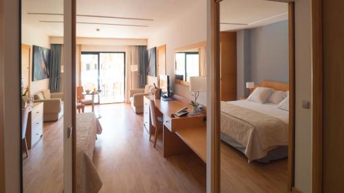 a hotel room with a bed and a mirror at Hotel Clipper - EL DELFÍN VERDE RESORTS - Platja de Pals in Torroella de Montgrí
