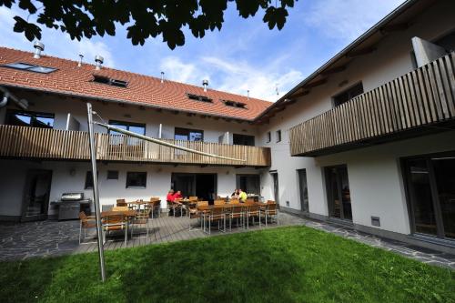 a courtyard of a building with tables and chairs at Hotel U Tří volů in Lysice
