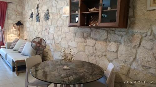 a dining room with a table and a stone wall at Siviri Traditional Stone House in Siviri