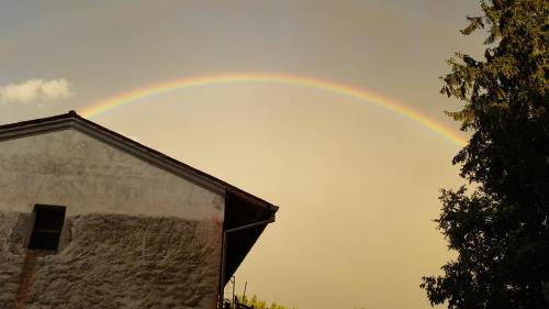 a rainbow in the sky over a building at Villa Mainardi Agriturismo in Camino al Tagliamento