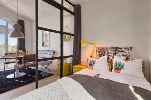 a bedroom with a large bed and a desk at Villa Marizella in Premantura