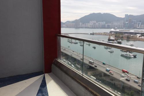 a balcony with a view of a river and freeway at IW Hotel in Hong Kong