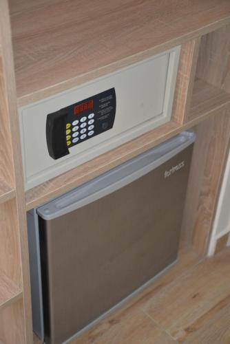 a microwave in a wooden cabinet with a drawer at IW Hotel in Hong Kong