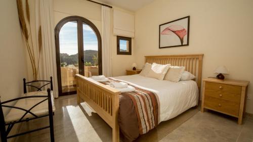 a bedroom with a large bed and a window at Coto Real Naxos 321 in Manilva