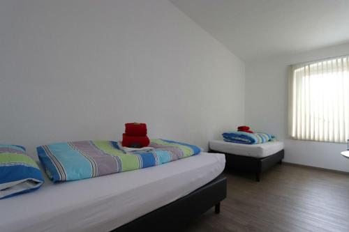 a bedroom with two beds and a window at PENNY Ferienwohnung in Velpke