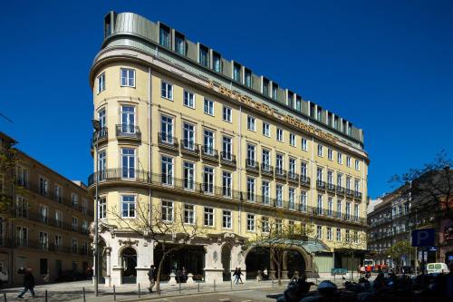 a tall building with people walking in front of it at Pestana Porto - A Brasileira, City Center & Heritage Building in Porto