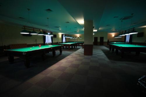 a billiard room with green tables in it at Hotel Kruiz in Krasnodar