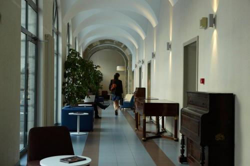 a person walking down a hallway in a building at Résidence Villemanzy in Lyon