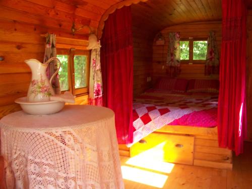 a bedroom with a bed in a wooden cabin at la boutique de laurence in Ségrie-Fontaine