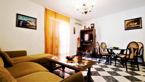 a living room with a couch and a table at Apartment Glomazic in Budva