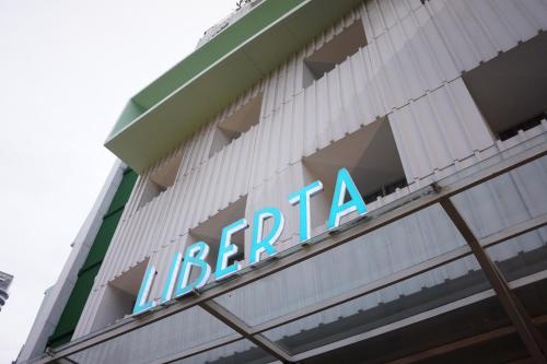 a sign on the side of a building at Liberta Hotel Kemang in Jakarta