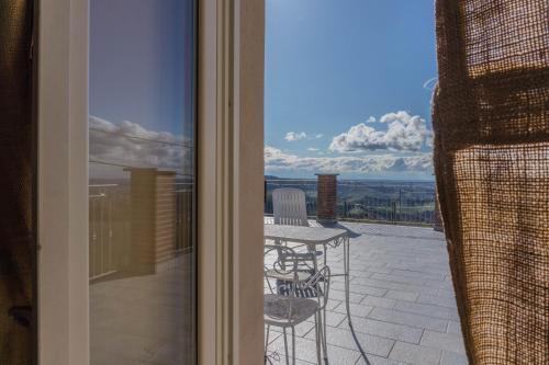 a view of a balcony with a table and chairs at B&B La Buonora in Sinio