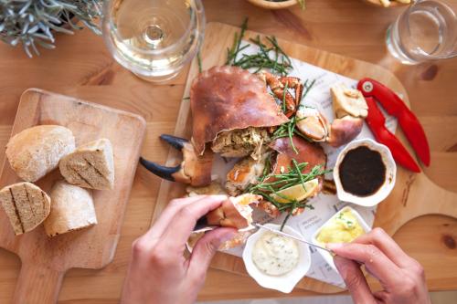 a person is eating a sandwich on a table at Lulworth Lodge in Lulworth Cove
