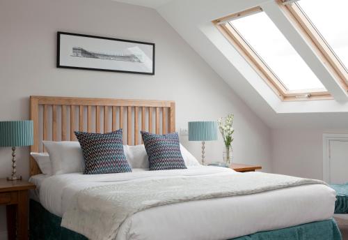 a bedroom with a large bed with blue and white pillows at 2 Crescent Gardens Guest House in Bath