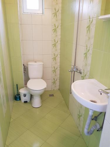 a bathroom with a toilet and a sink at Guest Rooms Radost in Balchik