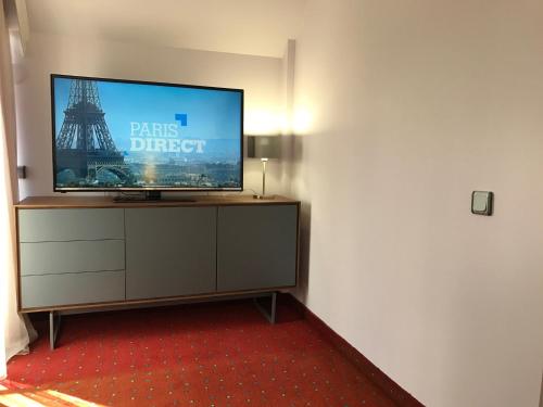 a flat screen tv sitting on top of a dresser at Art 'Otel in Sofia