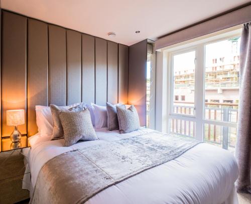a bedroom with a large bed with a large window at Riverside Retreat - Durham in Durham