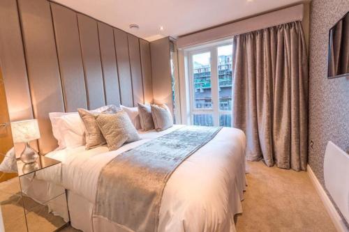 a bedroom with a large bed with a large window at Riverside Retreat - Durham in Durham