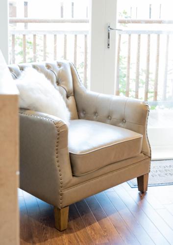a brown leather couch sitting in a living room at Riverside Retreat - Durham in Durham