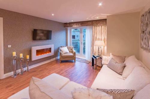 a living room with a couch and a fireplace at Riverside Retreat - Durham in Durham
