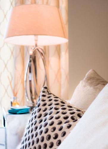 a lamp sitting on a table next to a bed at Riverside Retreat - Durham in Durham
